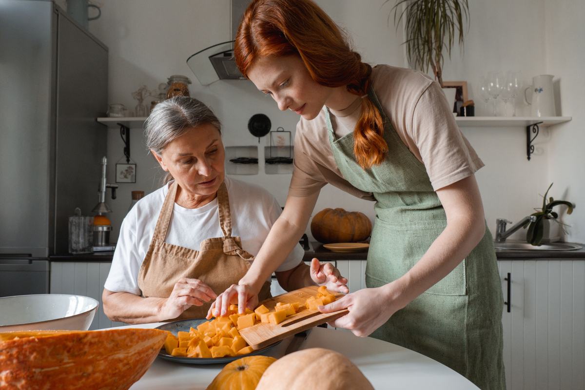 A photo of a daughter making soup with her elderly mother
